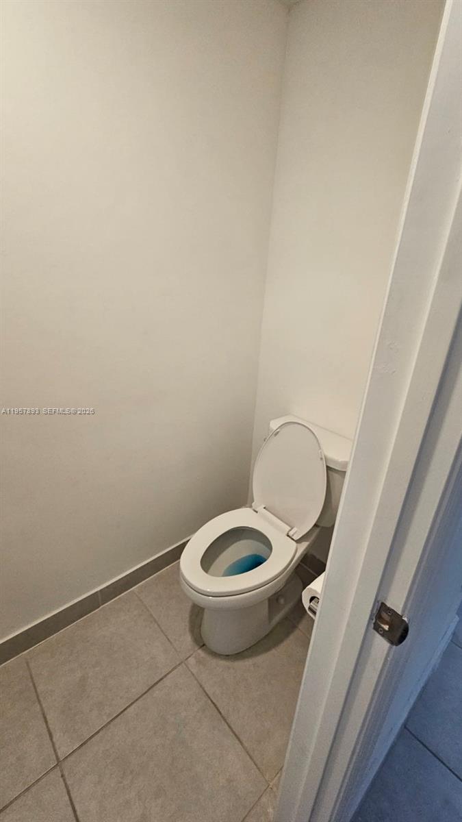 1146 Southeast 26th Street Homestead, FL 33035 - Photo 29 of 42 a white toilet sitting next to a shower