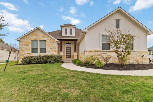 a front view of a house with a yard
