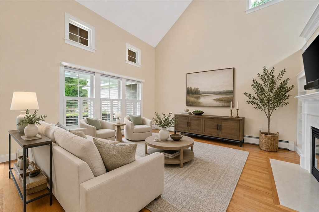 14 Sugar Maple Circle, Unit 14 Hanover, MA 02339 - Photo 8 of 38 a living room with furniture wooden floor and a large window