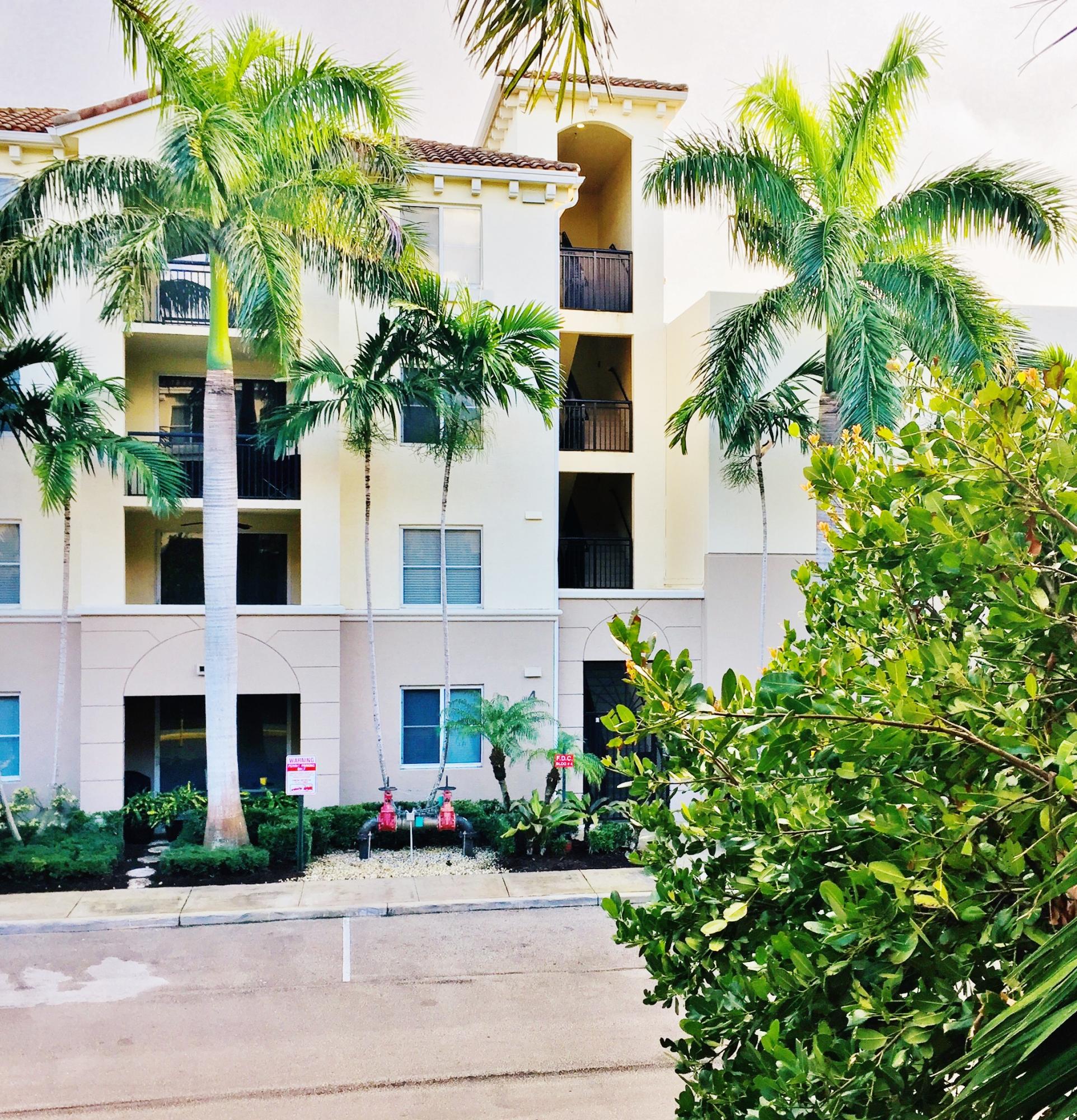 1203 Renaissance Way Boynton Beach, FL 33426 - Photo 14 of 24 a front view of a multi story building with yard
