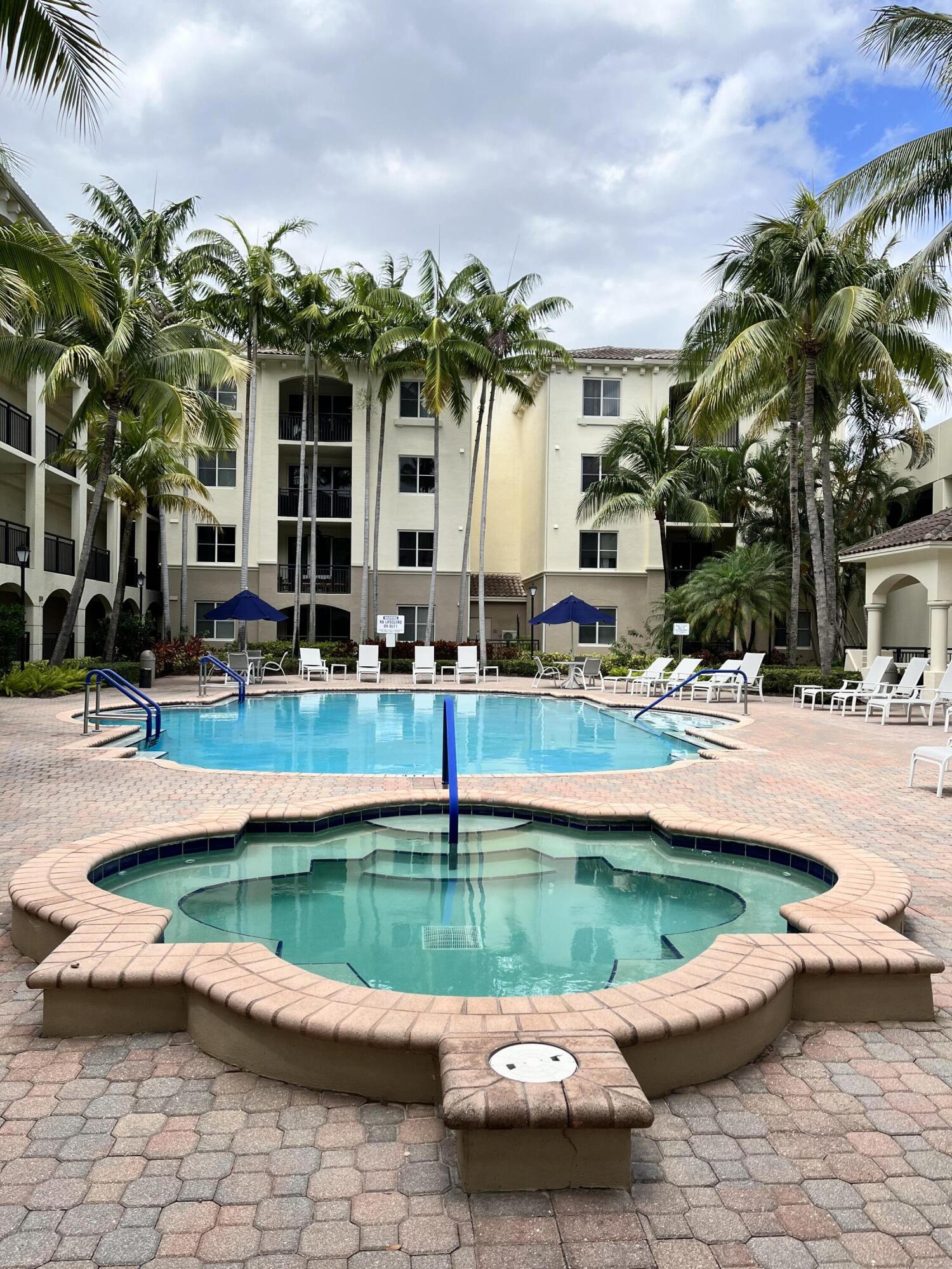 1203 Renaissance Way Boynton Beach, FL 33426 - Photo 23 of 24 a house with swimming pool and lake view