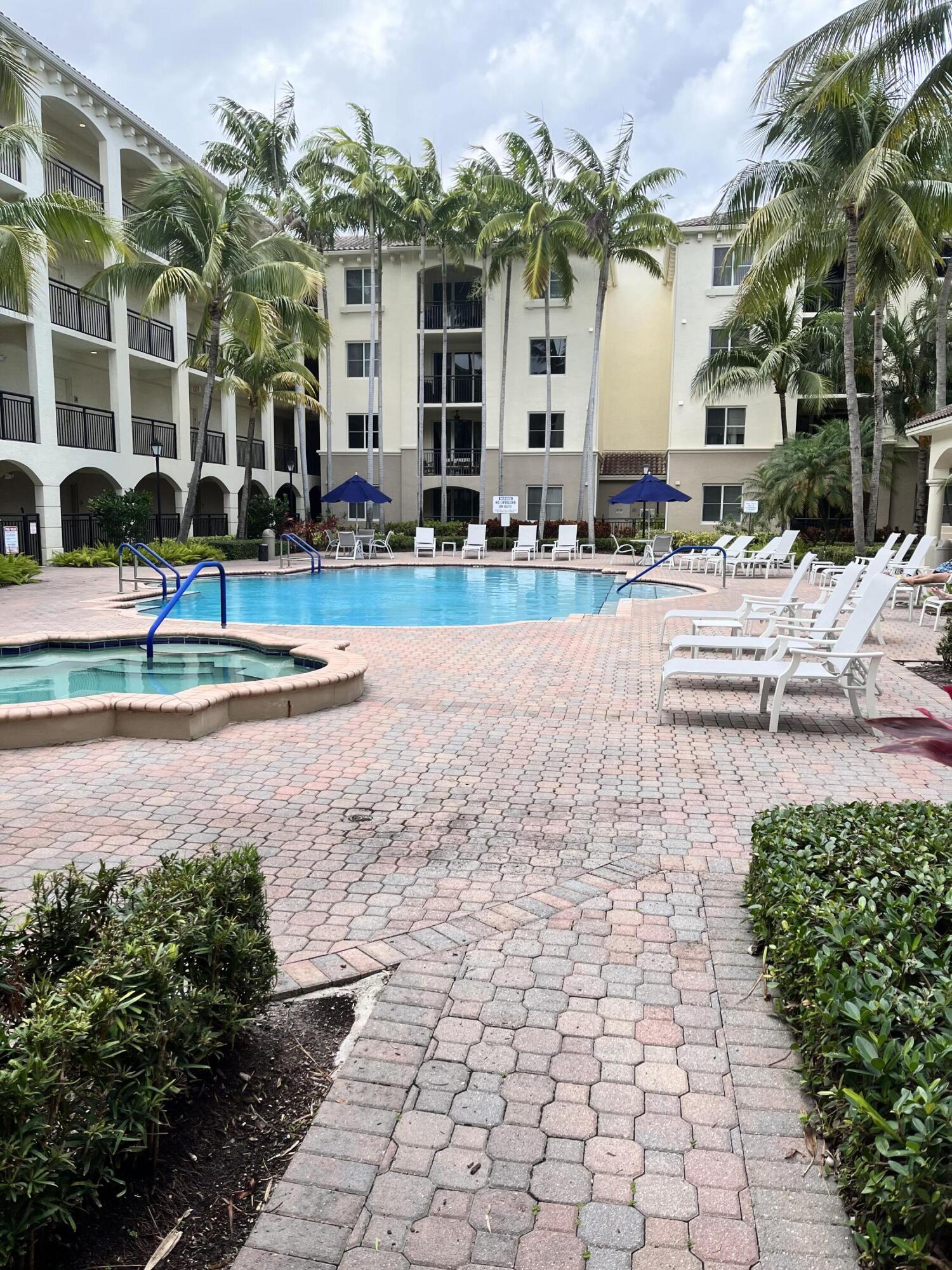 1203 Renaissance Way Boynton Beach, FL 33426 - Photo 24 of 24 a front view of a building with garden and trees