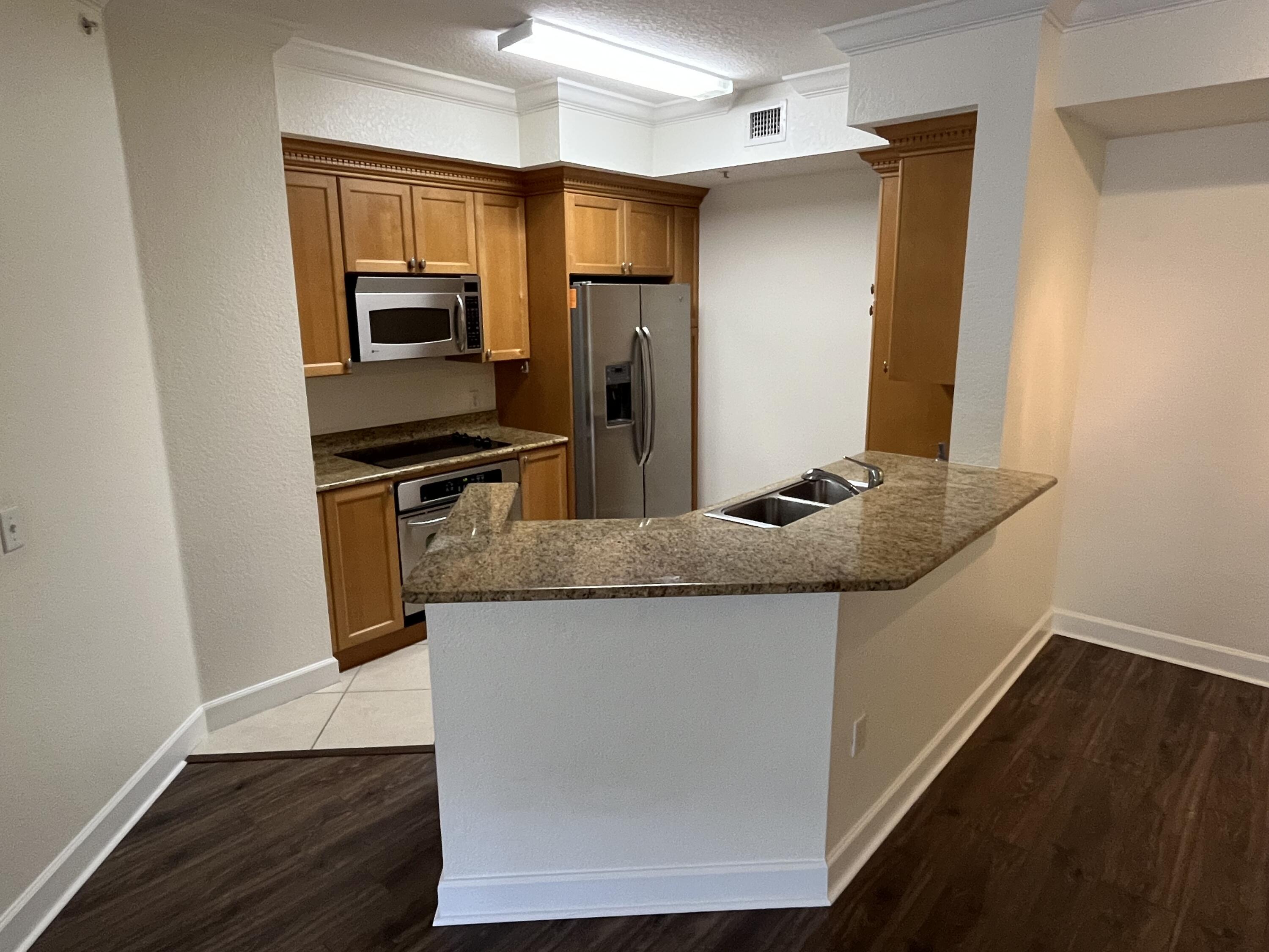 1203 Renaissance Way Boynton Beach, FL 33426 - Photo 3 of 24 a kitchen with stainless steel appliances granite countertop a refrigerator and a stove