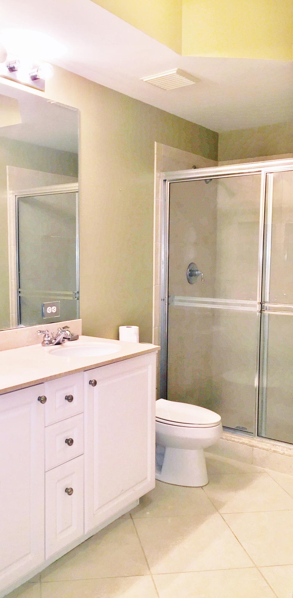 1203 Renaissance Way Boynton Beach, FL 33426 - Photo 7 of 24 a bathroom with a granite countertop sink toilet and shower