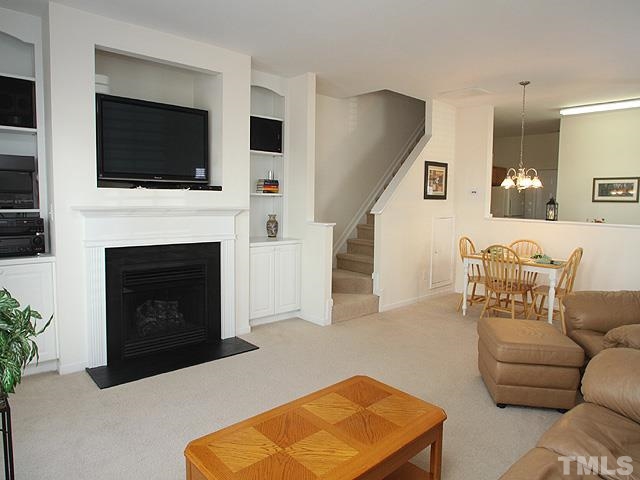 2170 Metacomet Way Raleigh, NC 27604 - Photo 3 of 15 a living room with furniture a flat screen tv and a fireplace