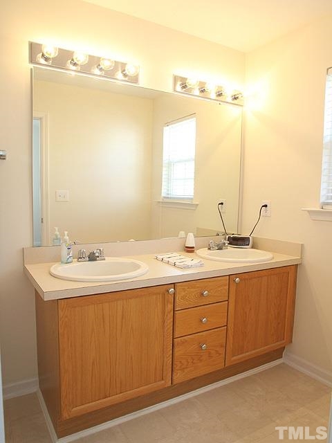 2170 Metacomet Way Raleigh, NC 27604 - Photo 8 of 15 a bathroom with a sink and a mirror