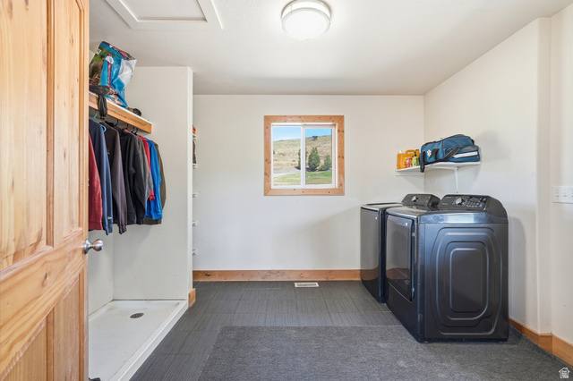 306 Spring Road Preston, ID 83263 - Photo 25 of 55 Dedicated laundry area featuring modern appliances, tile flooring, a window with wood trim, and a built-in hanging rack with shelving