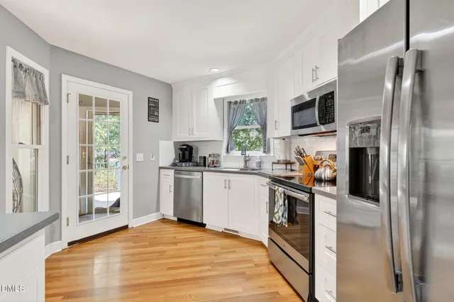 a kitchen with stainless steel appliances a refrigerator sink and stove