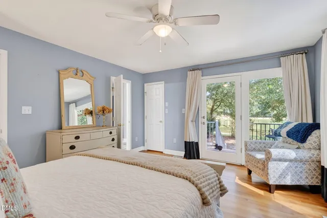 a bedroom with a bed and furniture with wooden floor