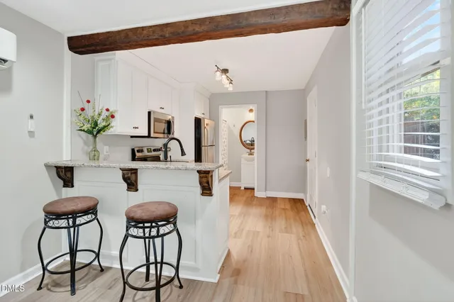 a hallway with a dining table and chairs