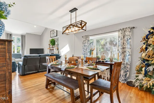 a view of a dining room with furniture window and wooden floor