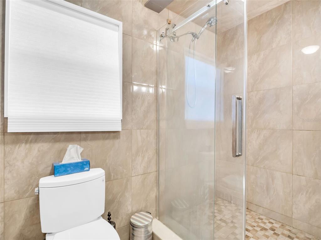 4915 S Road New Port Richey, FL 34652 - Photo 19 of 93 a white toilet sitting next to a bathroom sink