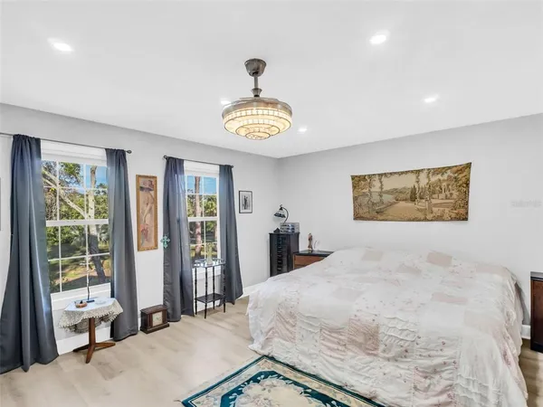 a bedroom with a bed and a television