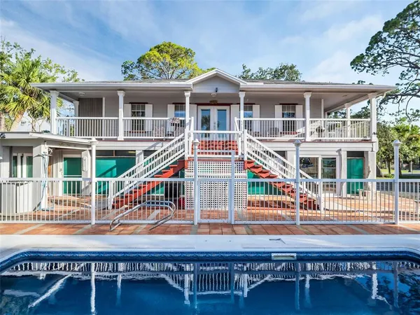 an aerial view of a house with yard swimming pool and outdoor seating