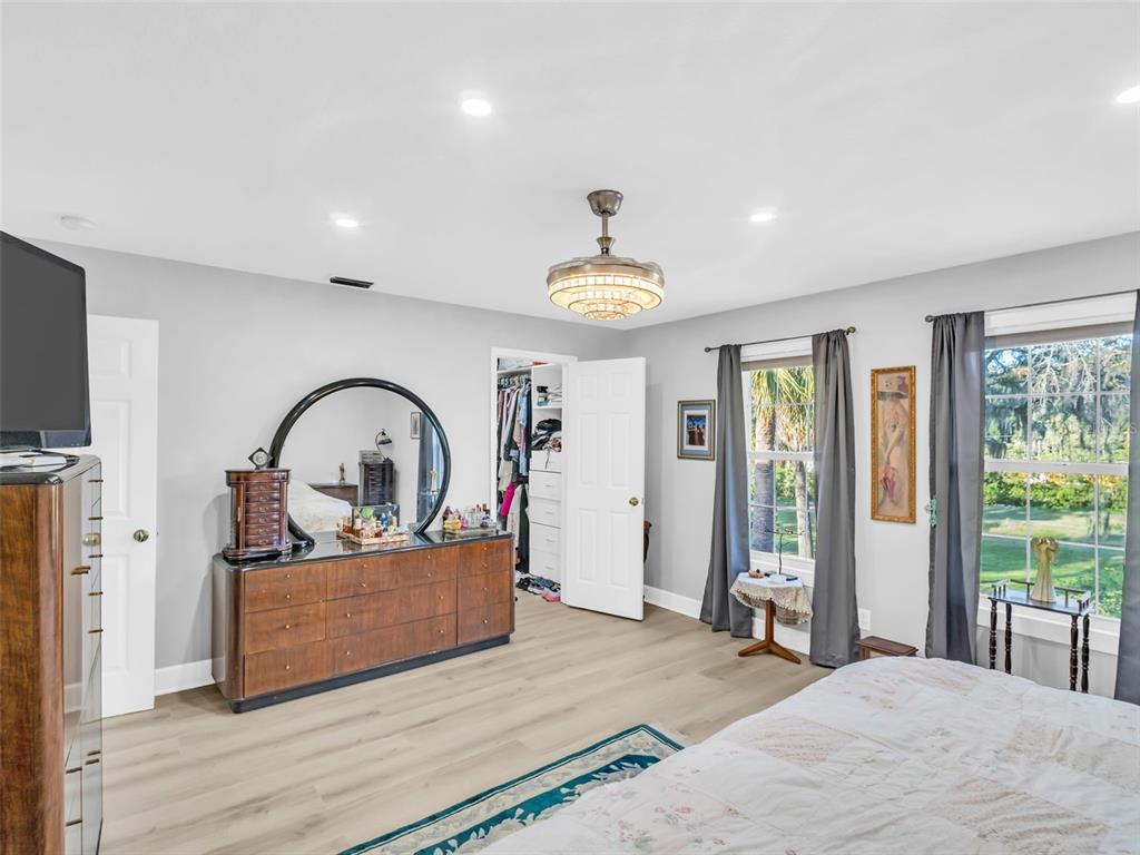 4915 S Road New Port Richey, FL 34652 - Photo 22 of 93 a living room with furniture a window and a flat screen tv