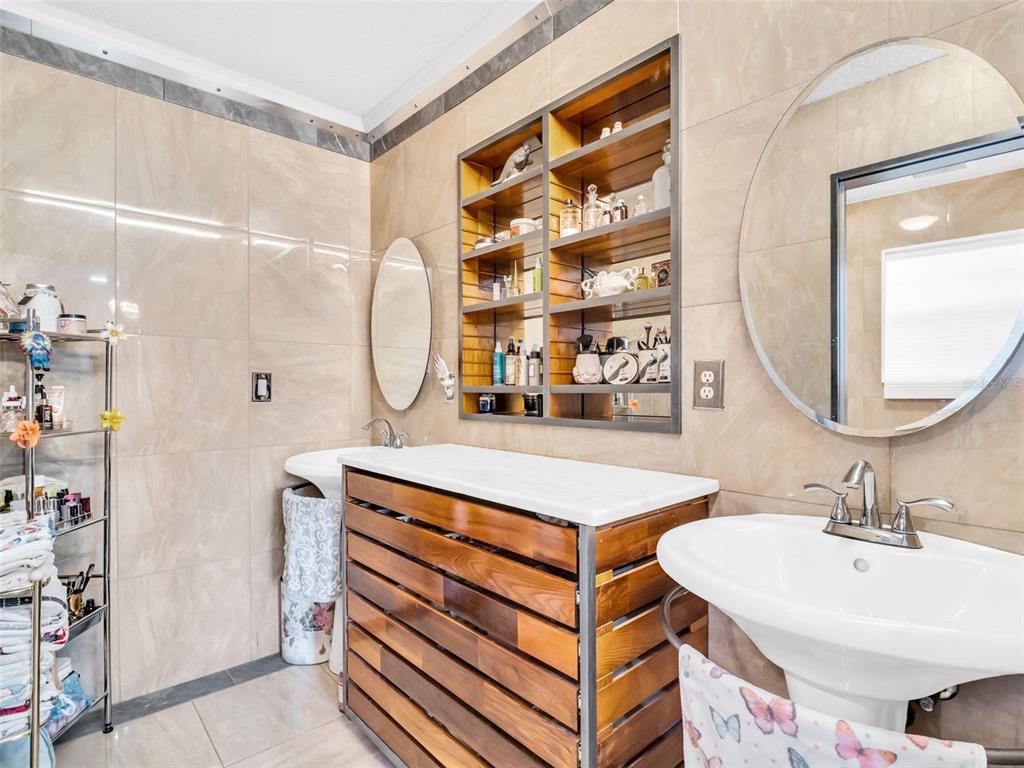 4915 S Road New Port Richey, FL 34652 - Photo 23 of 93 a bathroom with a sink mirror and a shower