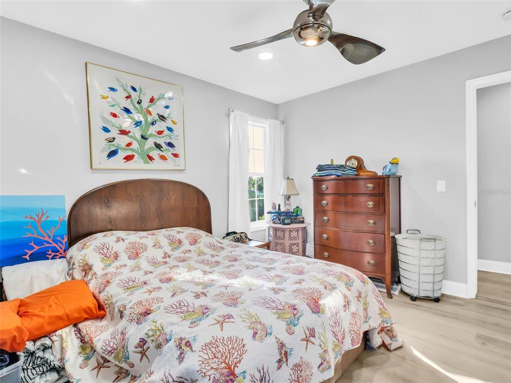 4915 S Road New Port Richey, FL 34652 - Photo 27 of 93 a bedroom with a bed and a chandelier