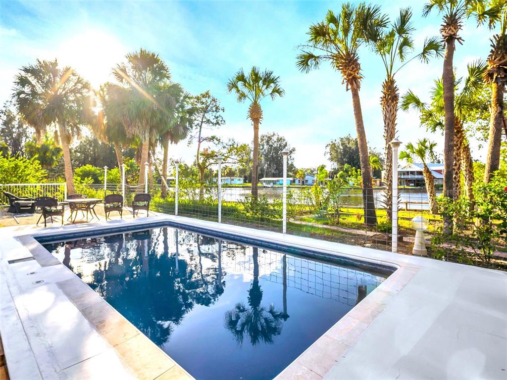 4915 S Road New Port Richey, FL 34652 - Photo 48 of 93 a view of a swimming pool with a patio
