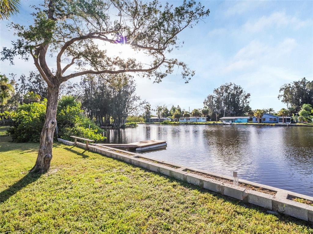 4915 S Road New Port Richey, FL 34652 - Photo 65 of 93 a view of a swimming pool with a lake view