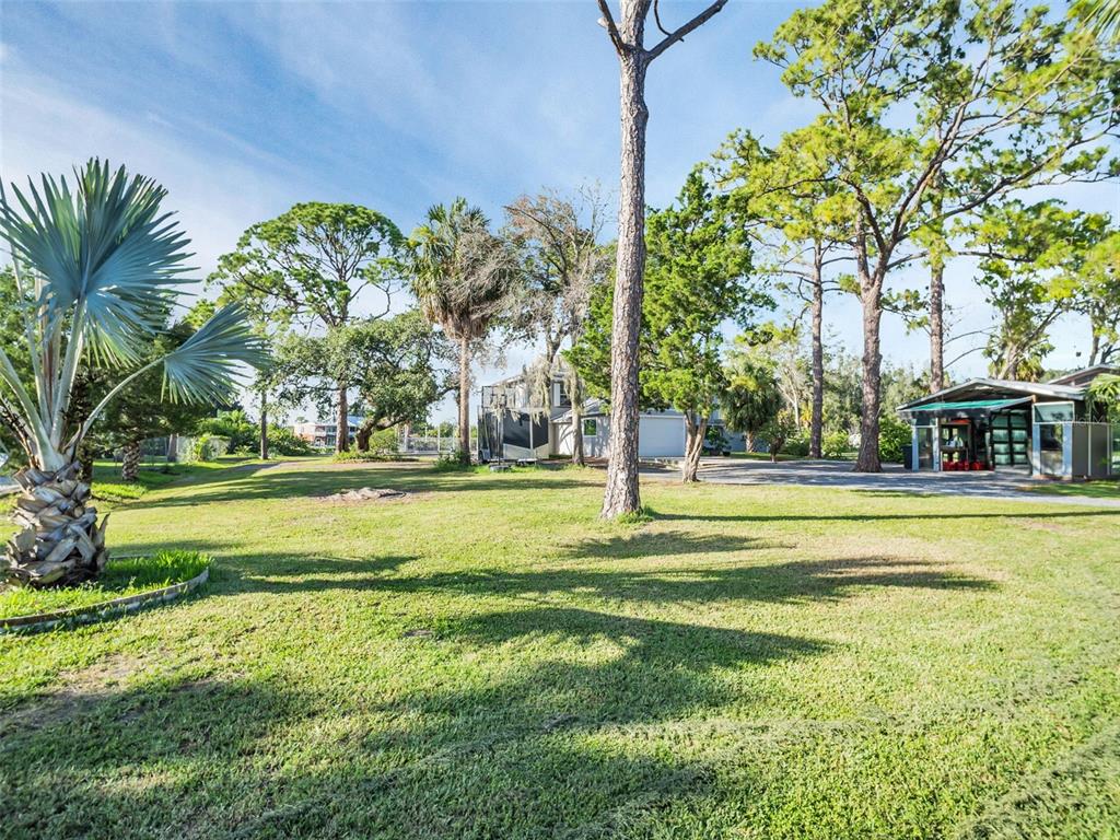 4915 S Road New Port Richey, FL 34652 - Photo 68 of 93 a swimming pool with outdoor seating and yard