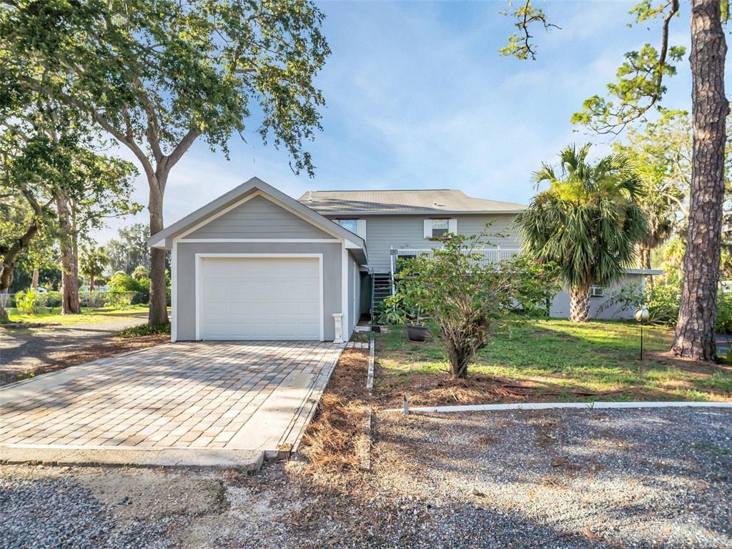 4915 S Road New Port Richey, FL 34652 - Photo 77 of 93 a front view of a house with a yard and garage