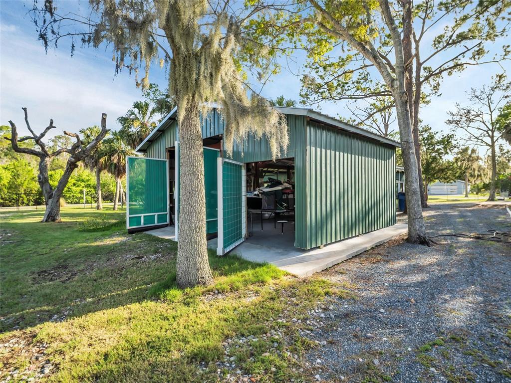 4915 S Road New Port Richey, FL 34652 - Photo 78 of 93 a view of a house with a small yard and a large tree