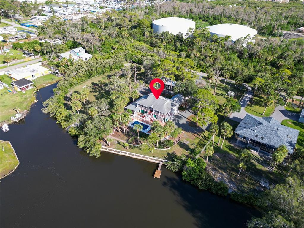 4915 S Road New Port Richey, FL 34652 - Photo 90 of 93 an aerial view of a house with a yard and lake view