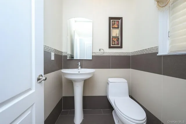a white toilet sitting next to a bathroom sink