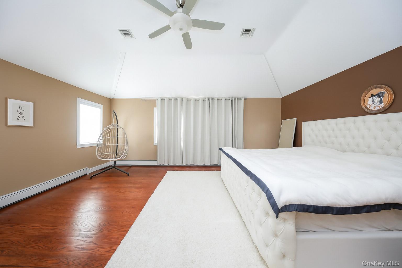 104 Highland Road Staten Island, NY 10308 - Photo 18 of 46 Bedroom featuring vaulted ceiling, ceiling fan, and wood finished floors