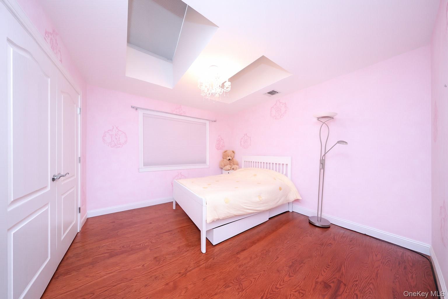 104 Highland Road Staten Island, NY 10308 - Photo 21 of 46 Bedroom with a chandelier and wood finished floors