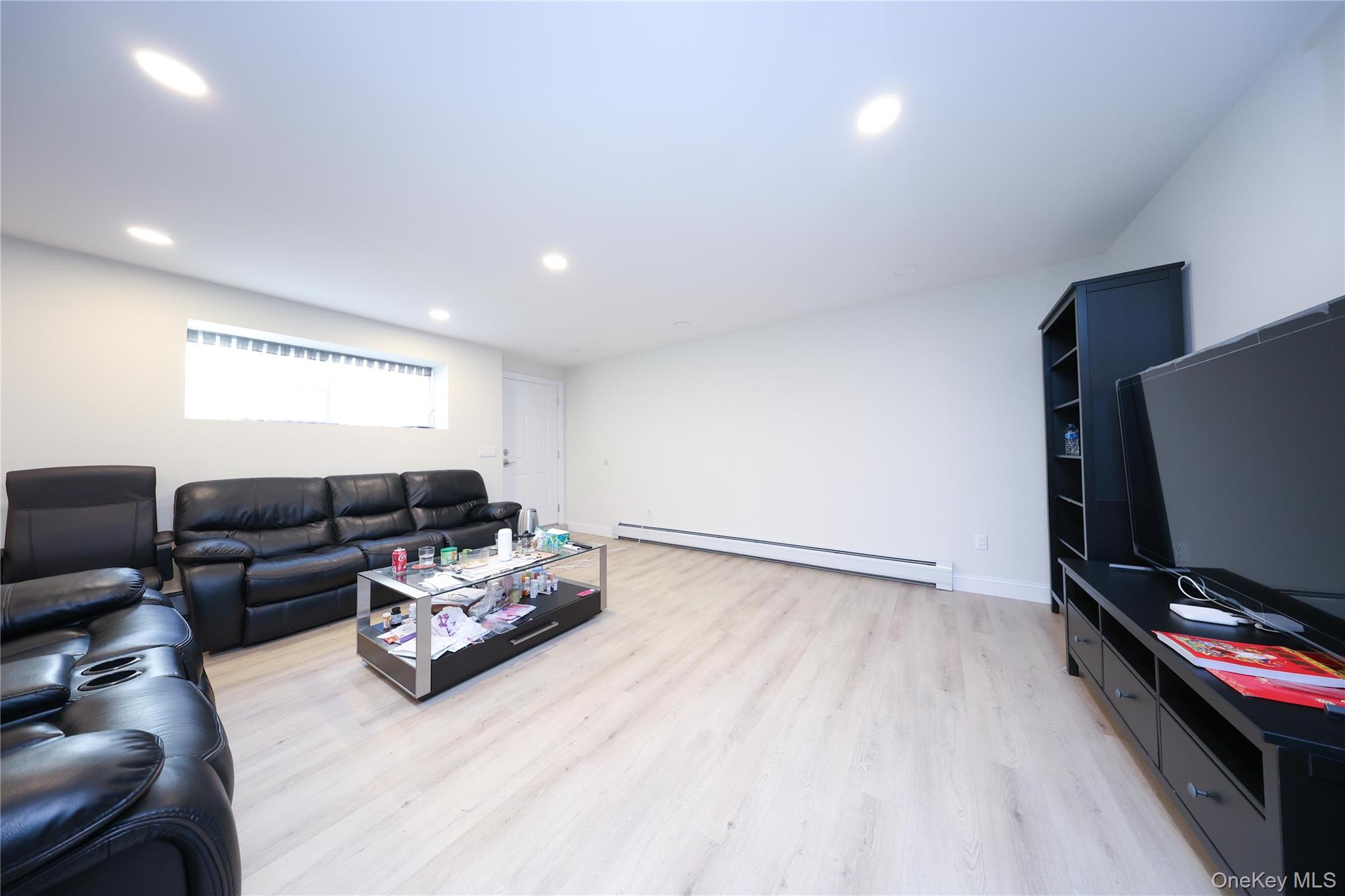 104 Highland Road Staten Island, NY 10308 - Photo 38 of 46 Living area with a baseboard heating unit, light wood finished floors, and recessed lighting