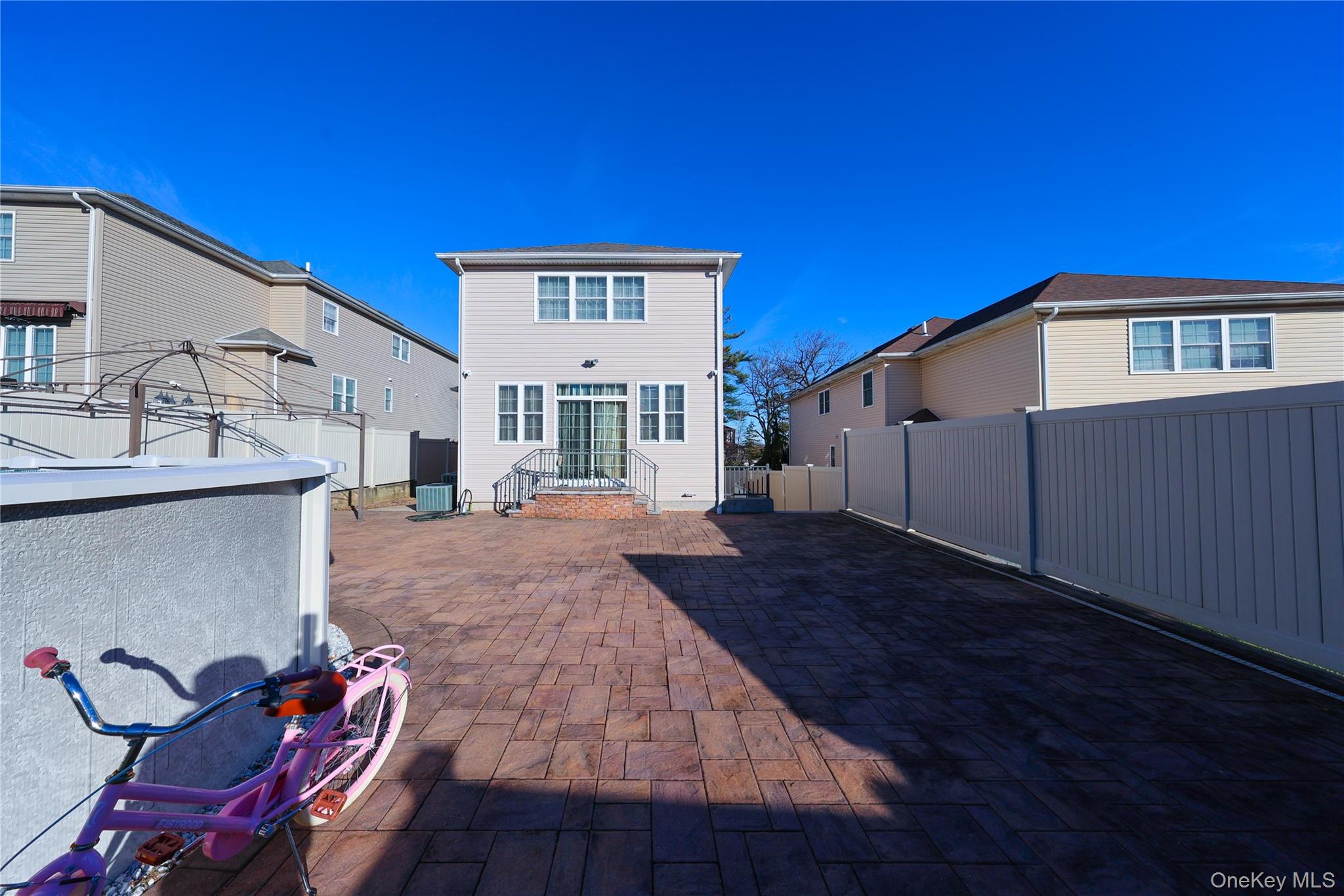 104 Highland Road Staten Island, NY 10308 - Photo 42 of 46 Rear view of property with a patio area and a fenced backyard