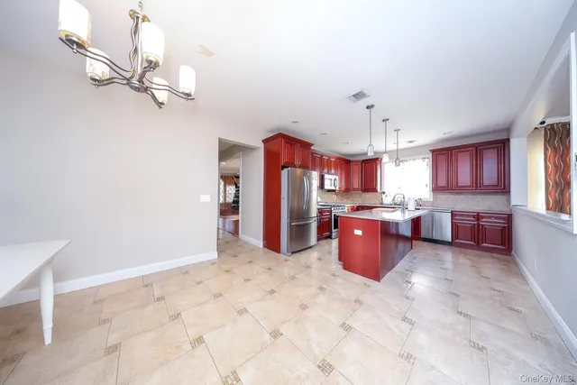 a large kitchen with a lot of cabinets and refrigerator