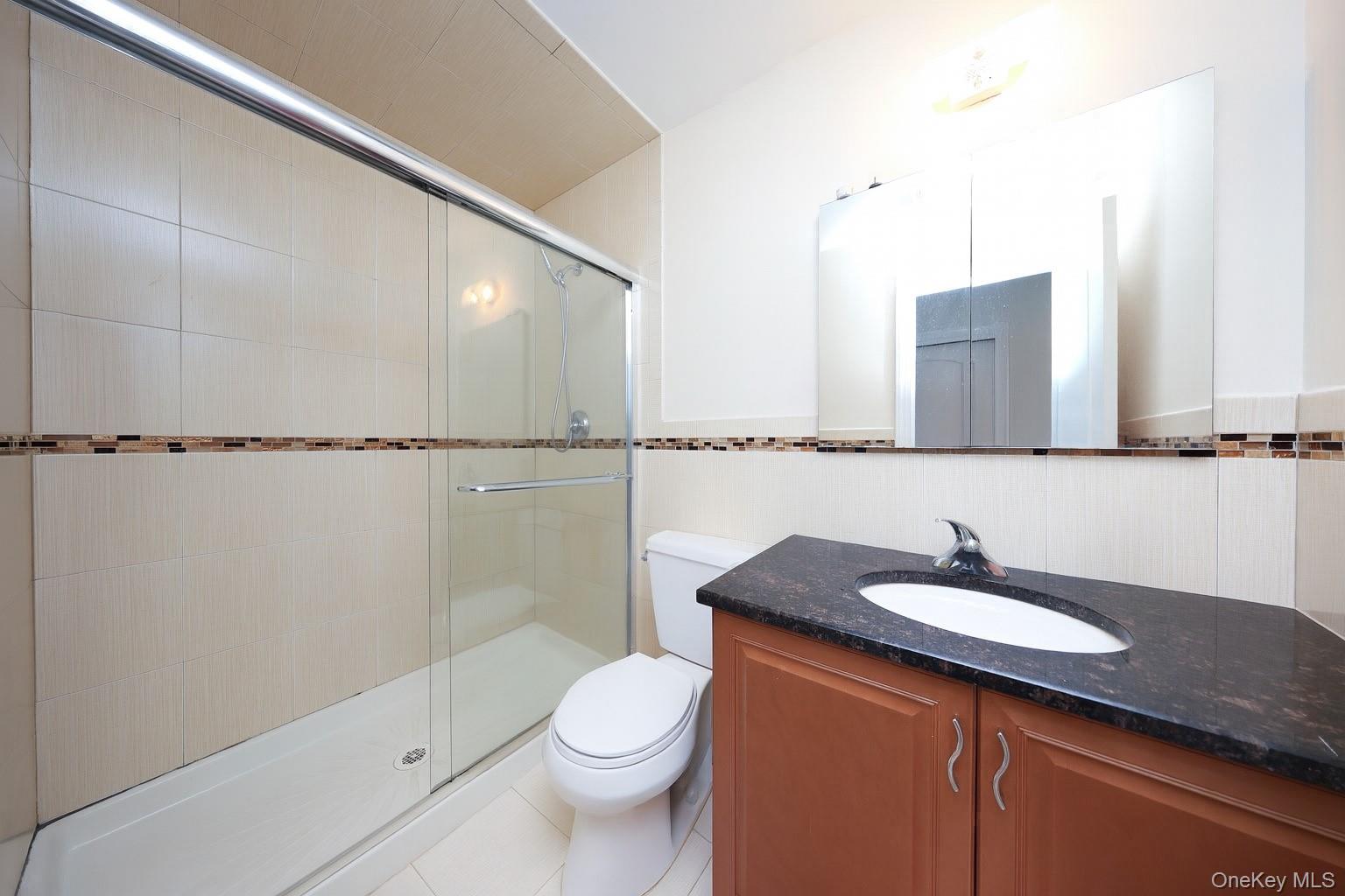 104 Highland Road Staten Island, NY 10308 - Photo 10 of 46 Full bathroom with vanity, a stall shower, and tile patterned flooring