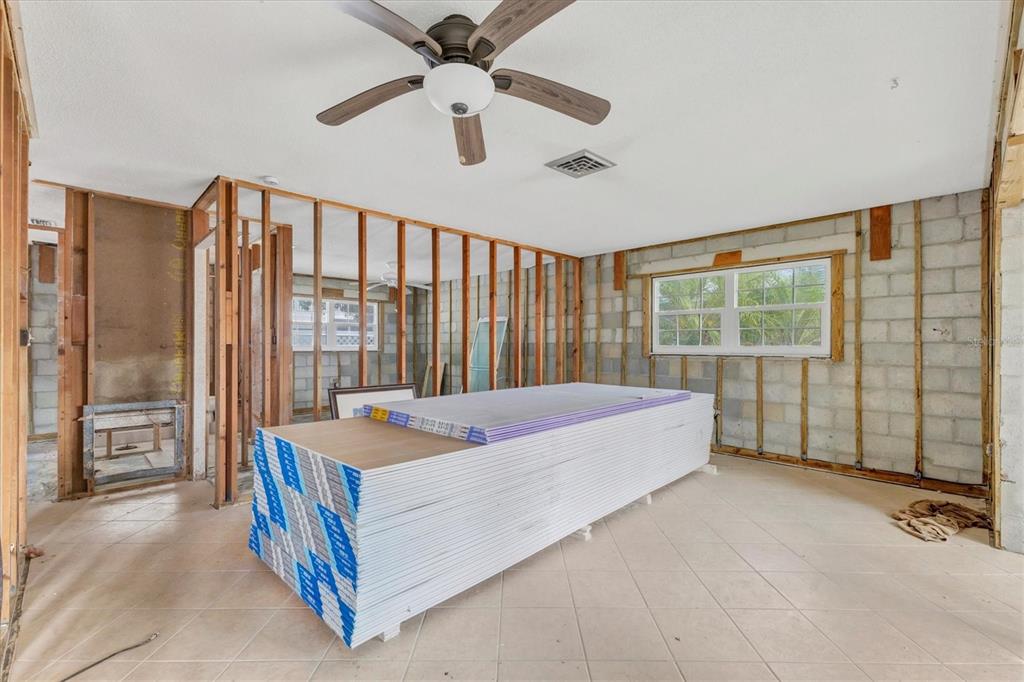 1977 Beach Road, Unit 19 Englewood, FL 34223 - Photo 13 of 47 a bed sitting in a spacious bedroom next to a window