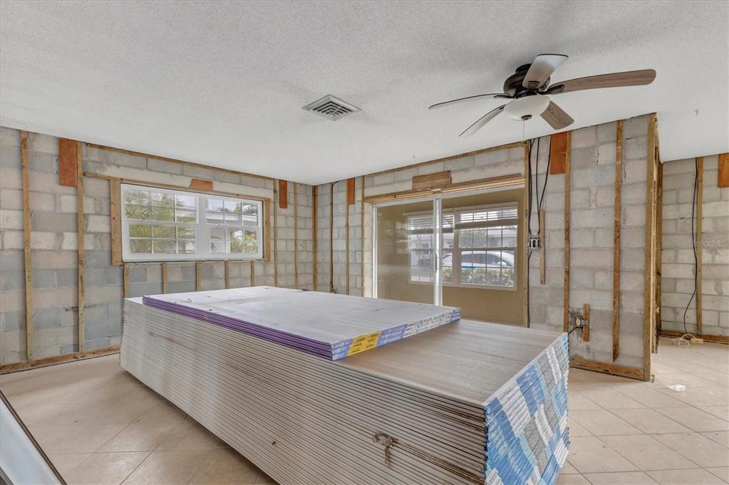 1977 Beach Road, Unit 19 Englewood, FL 34223 - Photo 14 of 47 a living room with a bed and a large window