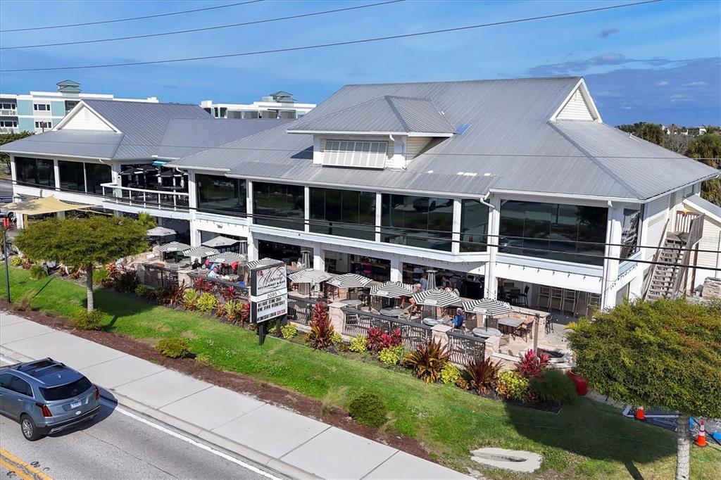 1977 Beach Road, Unit 19 Englewood, FL 34223 - Photo 41 of 47 a front view of a house with a yard table and chairs