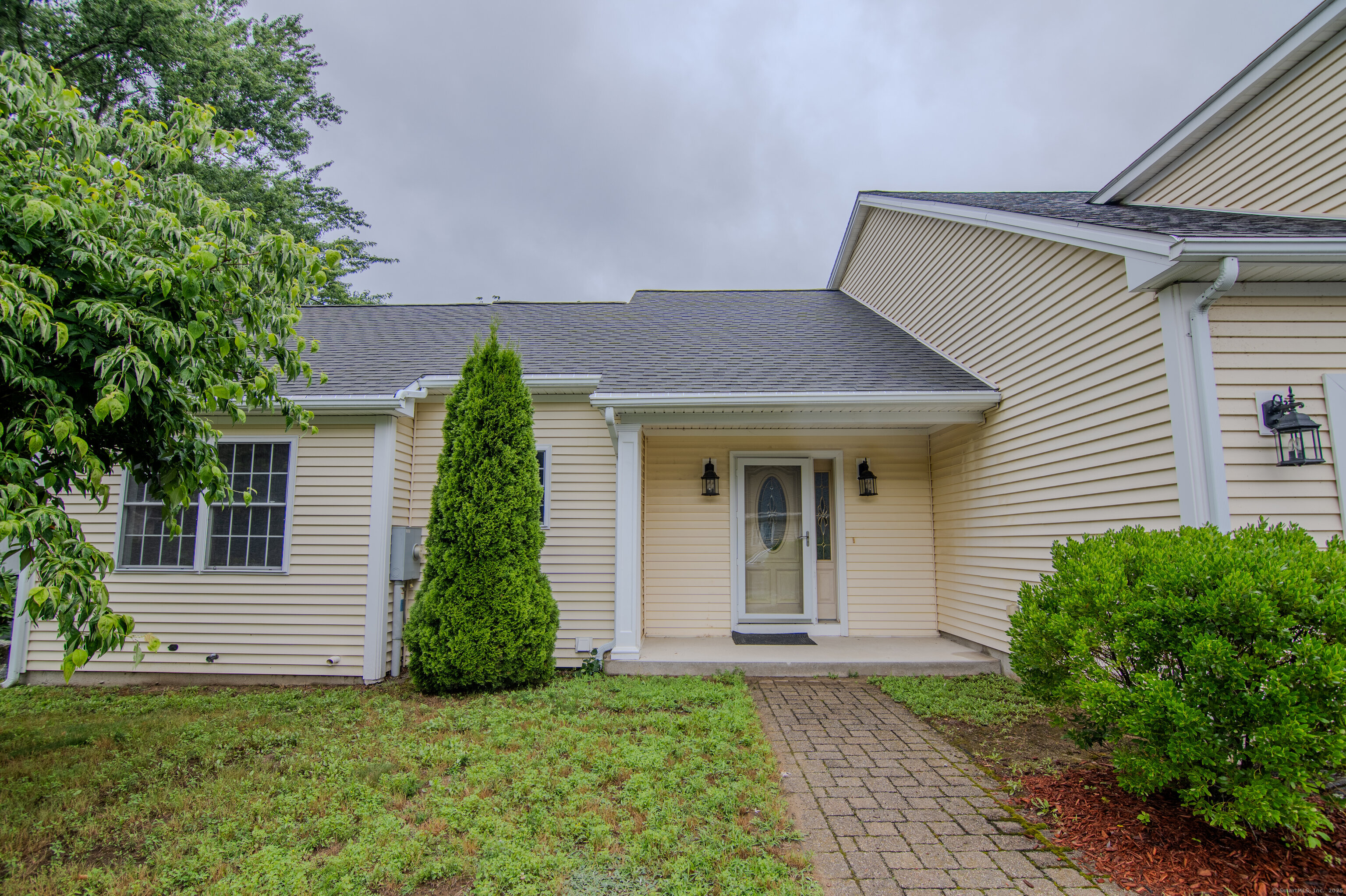 18 Isabellas Place, Unit 18 Killingly, CT 06239 - Photo 1 of 1 a front view of a house with a garden
