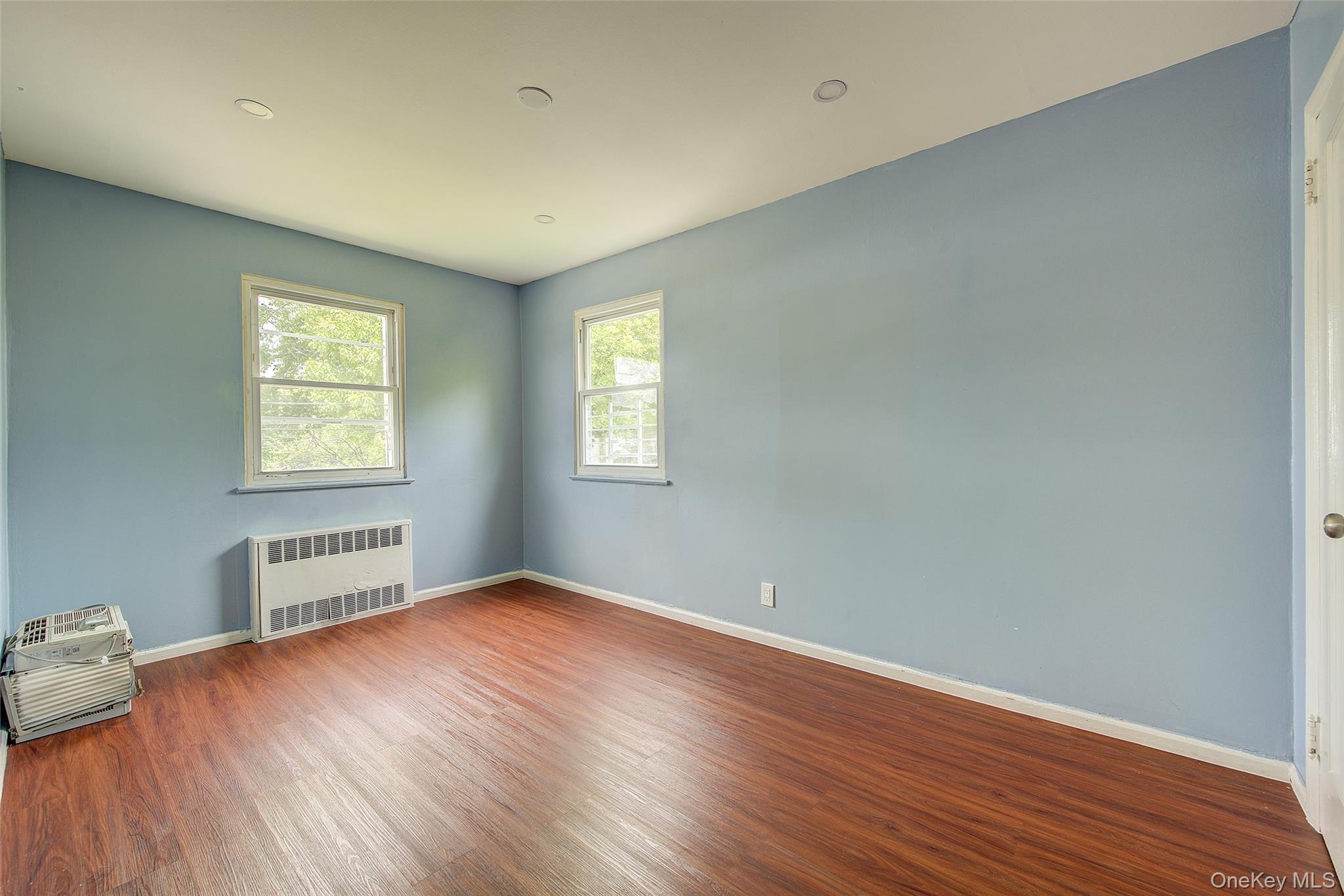 164-38 76th Road Queens, NY 11366 - Photo 23 of 44 an empty room with windows and closet