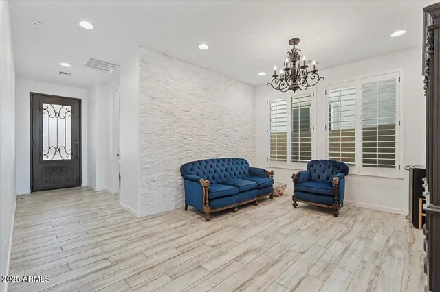 a living room with furniture and a chandelier