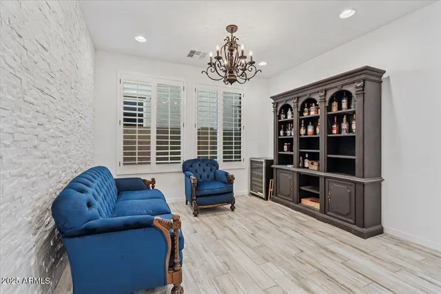 a living room with furniture and a floor to ceiling window