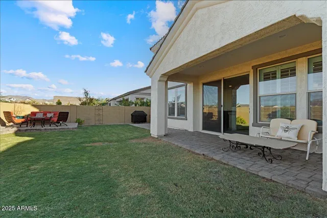 a view of a house with backyard porch and sitting area