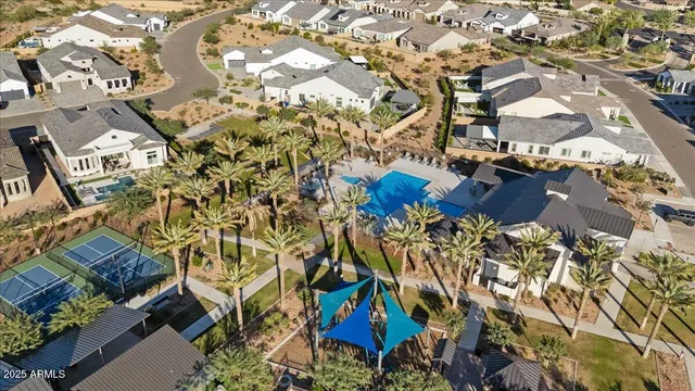 an aerial view of a house with a yard and outdoor seating
