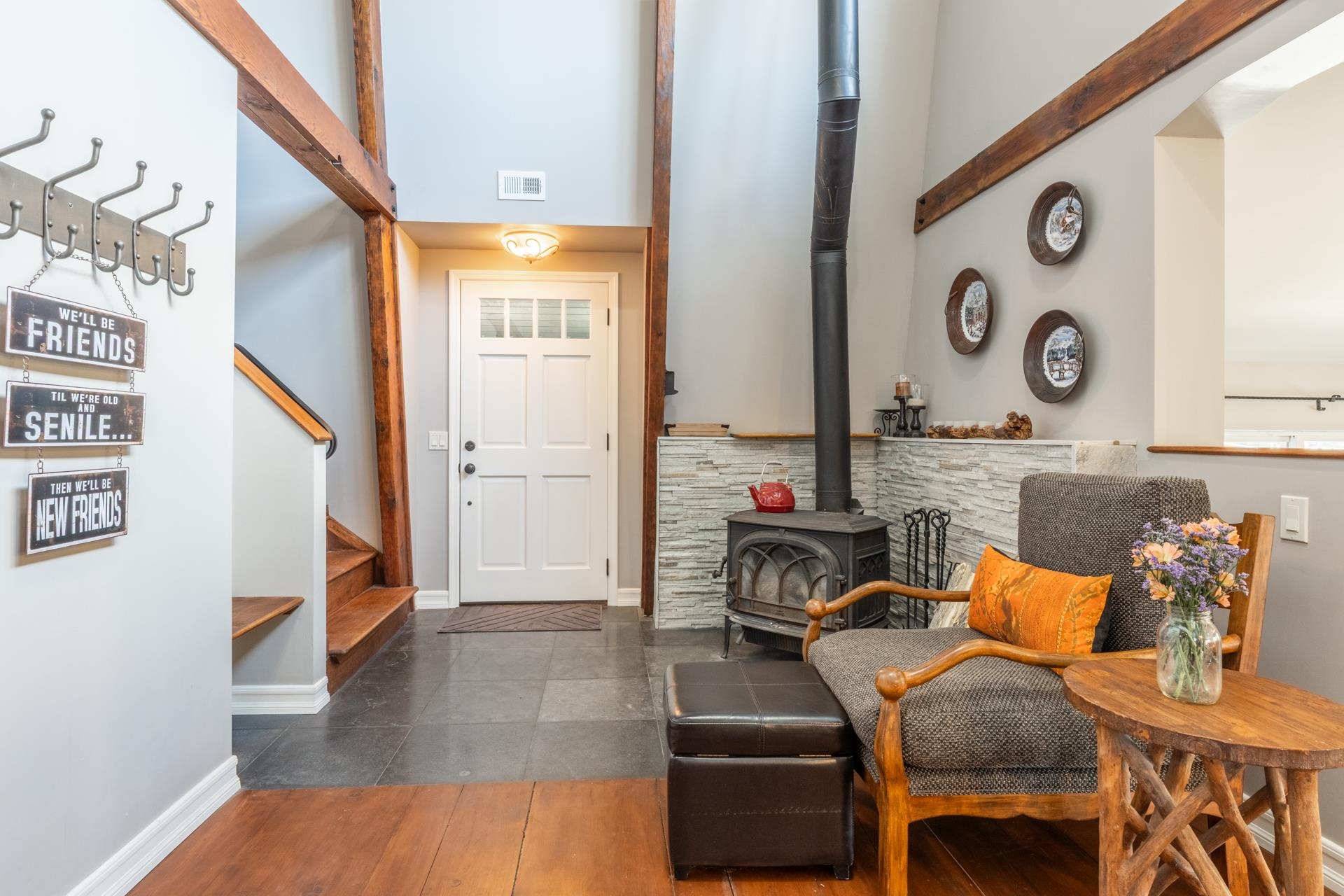 349 Davison Road Mammoth Lakes, CA 93546 - Photo 4 of 43 Foyer entrance featuring a wood stove, stairs, dark wood-style flooring, and a high ceiling