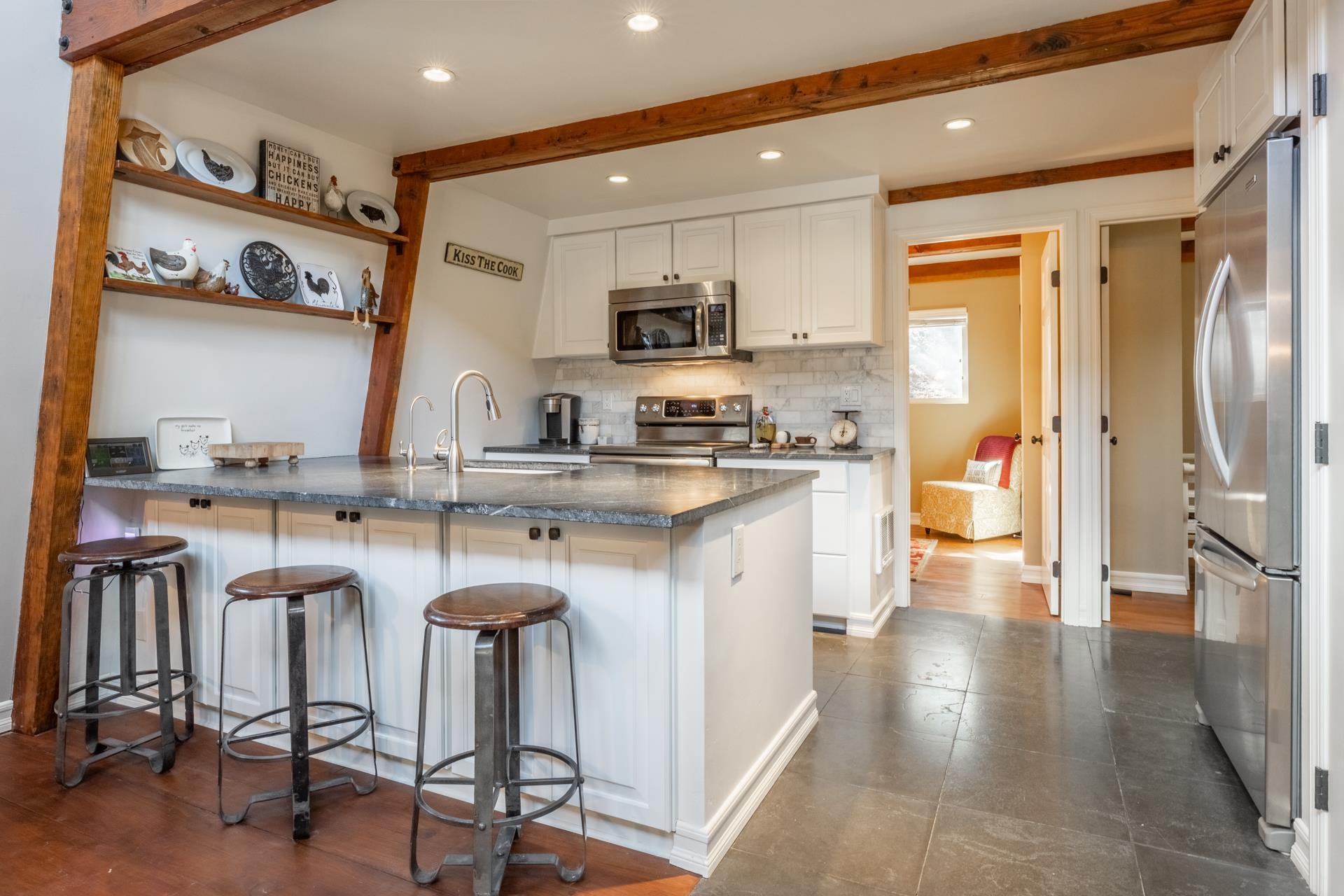 349 Davison Road Mammoth Lakes, CA 93546 - Photo 8 of 43 a kitchen with stainless steel appliances granite countertop a refrigerator a sink a stove and white cabinets with wooden floor