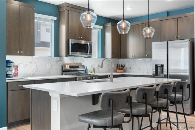 a large kitchen with a table and chairs