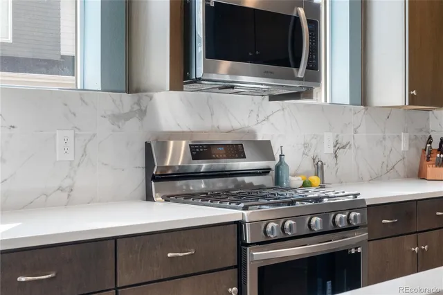 a kitchen with granite countertop a sink a center island and cabinets