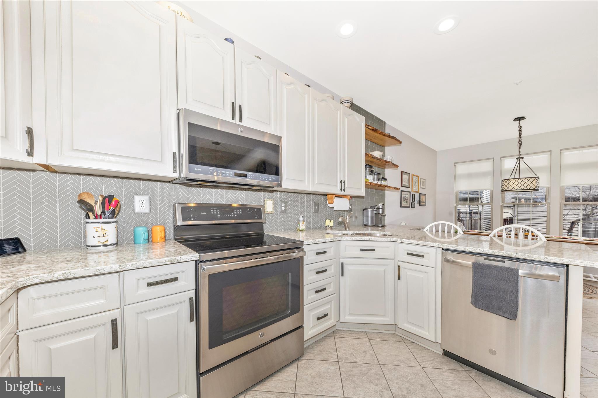 2205 Garden Lane Frederick, MD 21701 - Photo 12 of 48 a kitchen with white cabinets stainless steel appliances and sink
