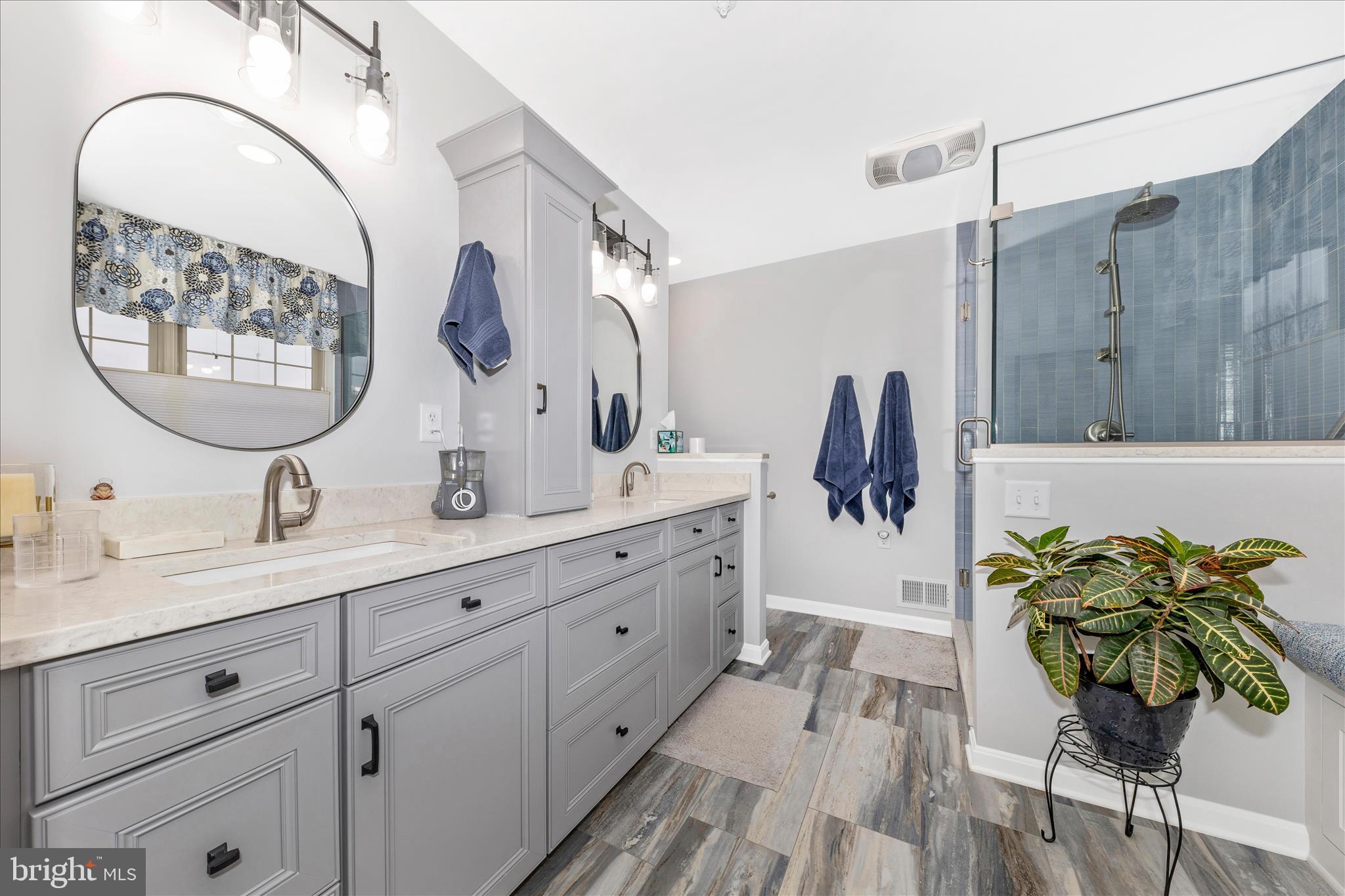2205 Garden Lane Frederick, MD 21701 - Photo 21 of 48 a bathroom with a granite countertop sink a potted plant and a mirror