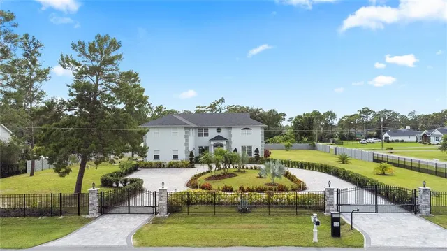 a swimming pool view with a seating space and a garden view